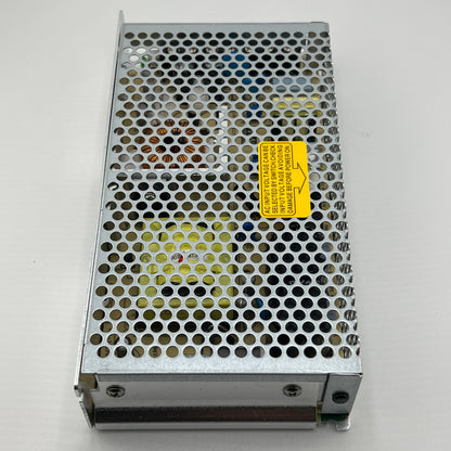 Metallic power supply unit with a yellow label on a gray background