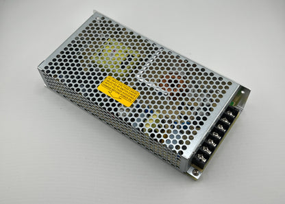 Rectangular metal power supply unit with a yellow label on a gray background