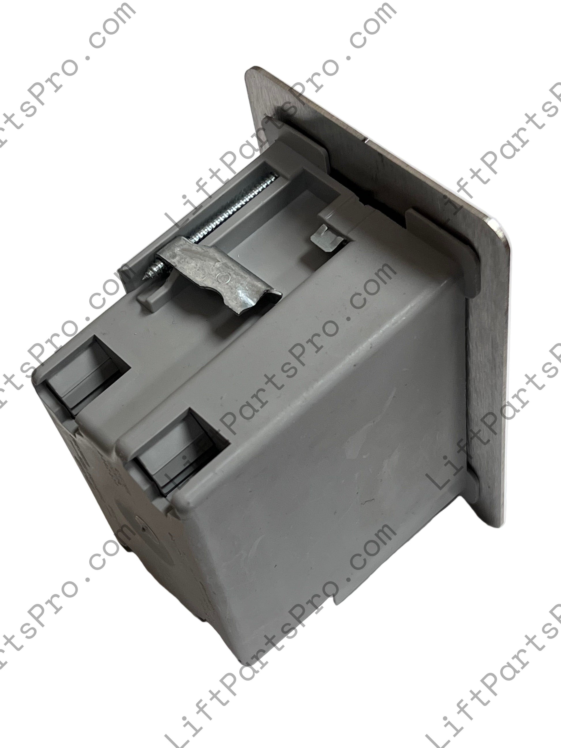 Top view of hall call station depicting stainless steel plate and gray plastic box.