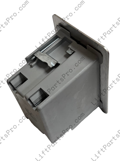 Top view of hall call station depicting stainless steel plate and gray plastic box.